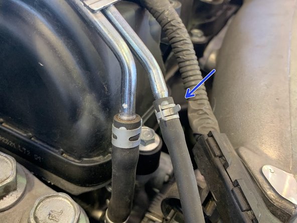 Using needle nose pliers, undo the clamp as shown and free the silicone hose from the hardline