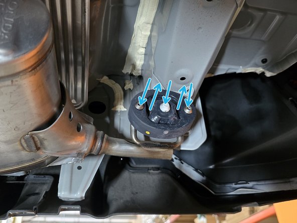 Use tongue &amp; groove pliers to press the rod out of the rubber hanger, remove the hangers of the exhaust from the rubber supports as shown