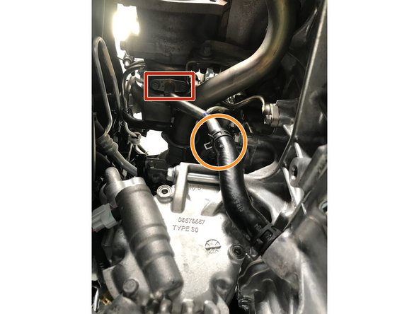 Use a 10mm socket &amp; ratchet to remove the two (2) 10mm bolts that attach the oil drain tube to the bottom of the turbo, set the bolts aside as they will not be reused.