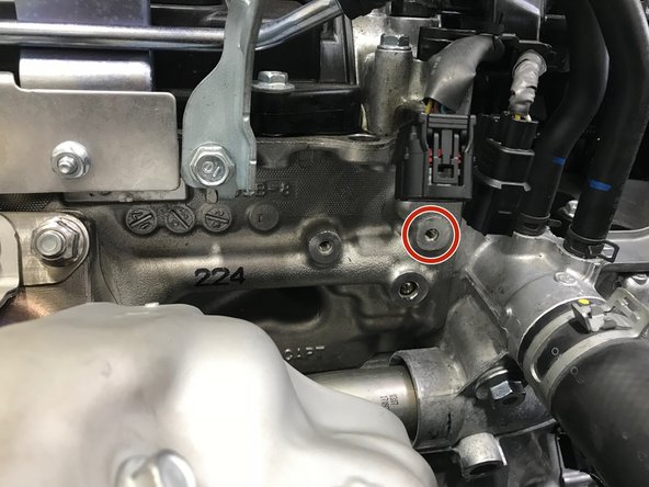 Install the bracket and hand tighten one (1) 10mm bolt into the engine shown with the red circle