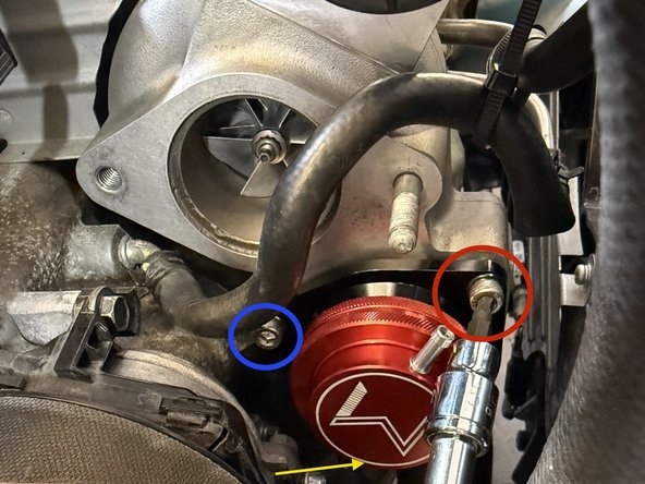 Using a 5mm ball end hex socket and 3” extension, guide the first fastener through the BPV mounting hole and thread onto turbocharger. Leave finger tight