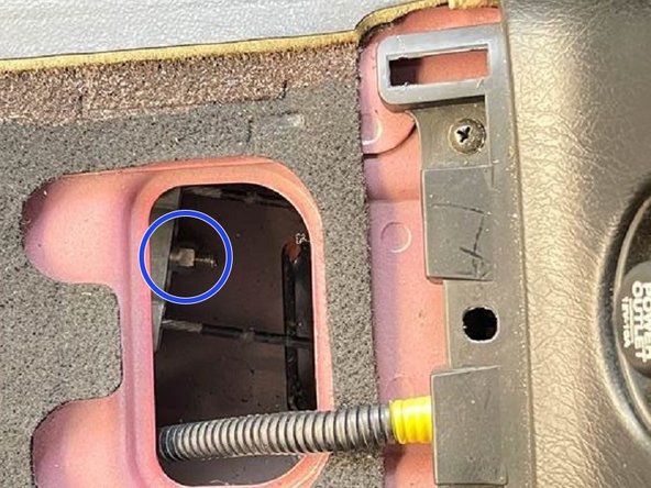 Using a 10mm socket, adjust the screw as needed to comply with the parking brake adjustment guideline