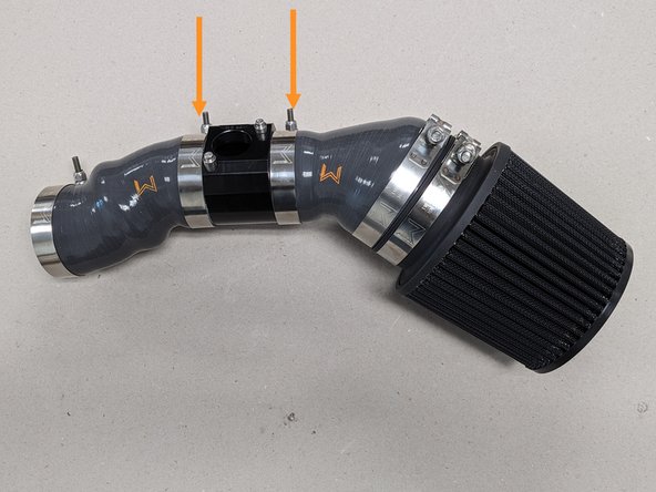 Using a 10mm socket and ratchet loosen the two (2) 70-78mm T-bolt clamps on either side of the MAF housing and remove MAF housing