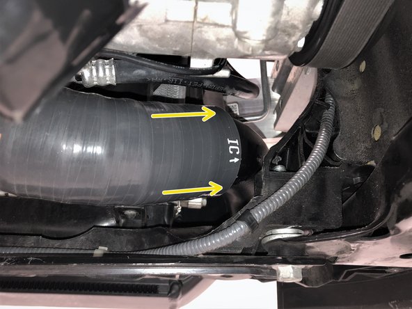 Lift the 27WON intercooler into position. Secure the driver's side by threading one of the supplied M10 bolts a few turns into the intercooler