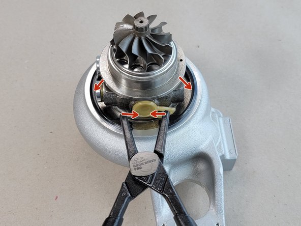 While holding the CHRA in the seated position compress the snap ring and set it into the groove in the compressor cover