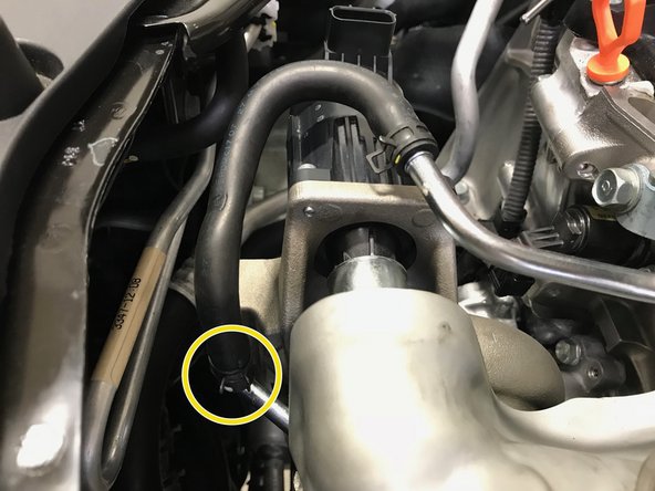 Use pliers to install the spring clamp at the end of the coolant hose around the upper coolant pipe