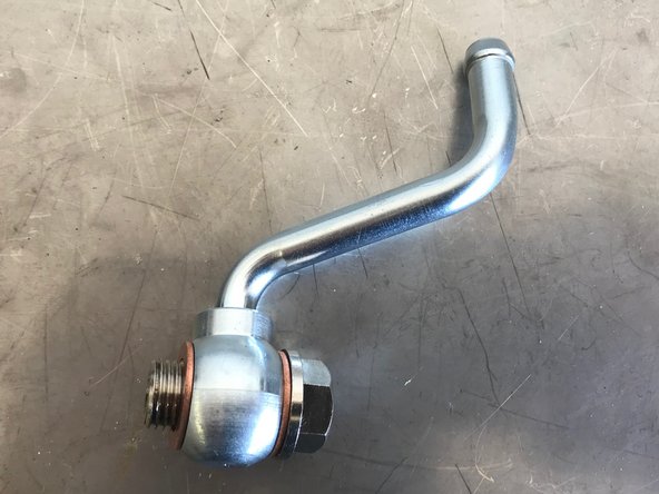 Assemble the upper coolant pipe as shown.  There should be one crush washer on each side of the coolant pipe bolt connection