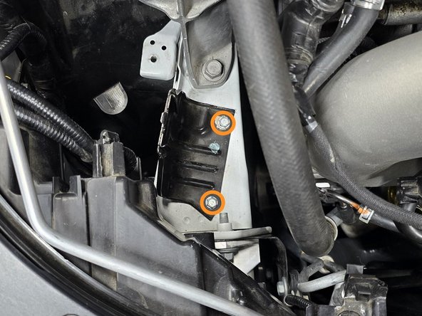 Use a 10mm socket, a 12" extension, and a 3/8" drive ratchet to remove the two bolts securing the OE bracket