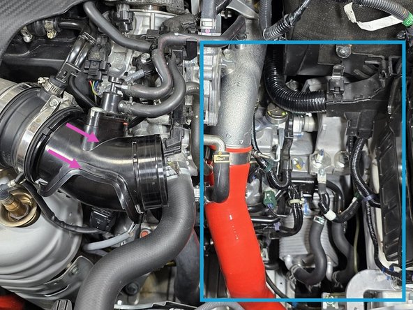 Wiggle the inlet back and forth while lifting on the entire airbox to get it loose from the grommet as shown