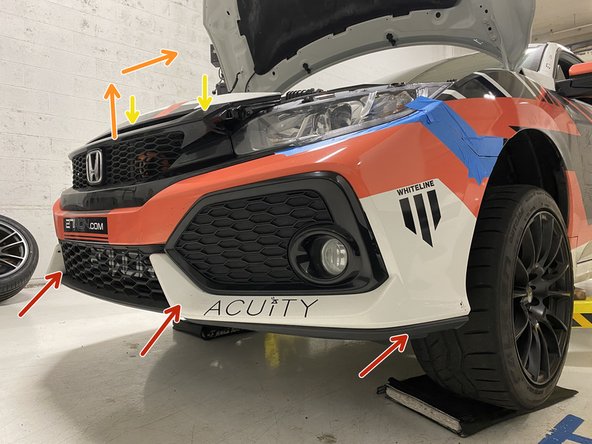 Start by lifting the bottom edge of the bumper into position first