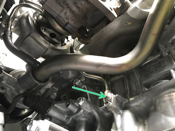 Locate the oil feed block connection location shown in the first image, you removed the oil drain line from it earlier