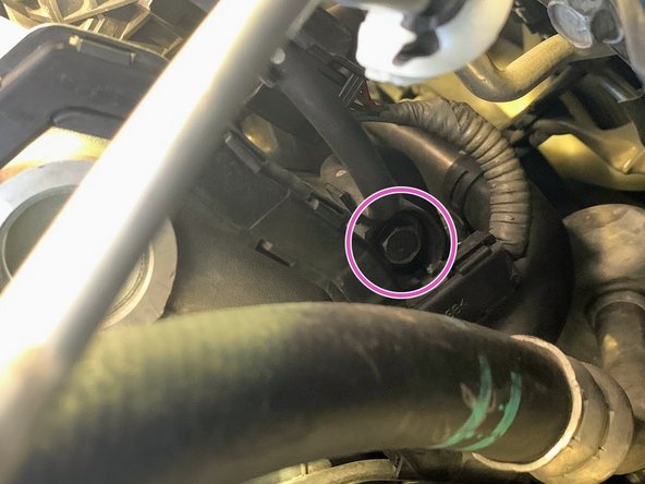 Using  the OE 10mm bolt reinstall the lower part of the vacuum line bracket as shown