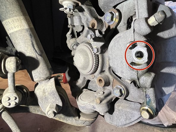 Disconnecting the brakeline will allow brake fluid to leak from the hard brakeline mounted to the chassis and the rubber brakeline on the caliper.  Use a rag to catch drips