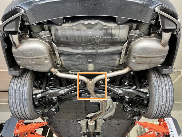 Using a transmission jack, floor jack, or a friend support the OE exhaust in the marked area