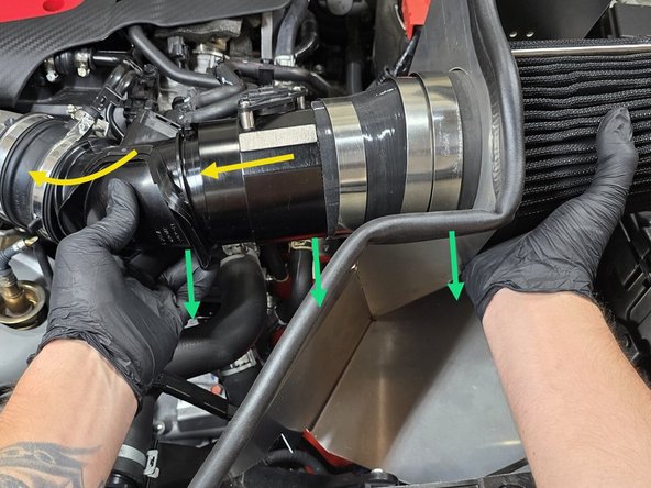 Partially lower the intake assembly into the engine bay