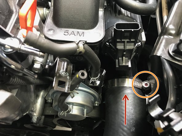 Pull the hose out and reinstall the band clamp in the same orientation it came off