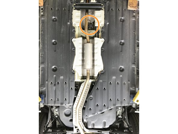 Locate the dual rod rubber hanger in the exhaust mid section