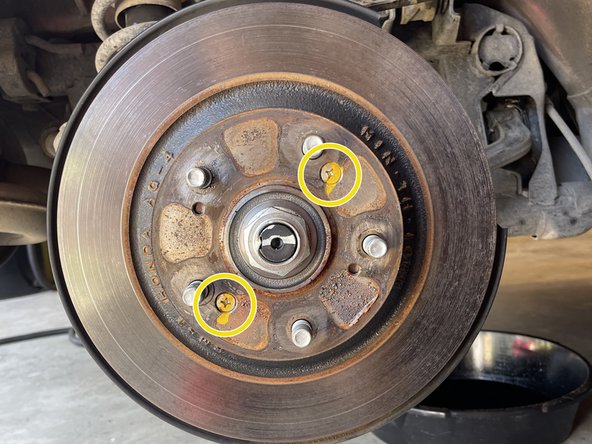 Using an impact driver and hammer, remove the (2) Phillips screws holding on the rotor