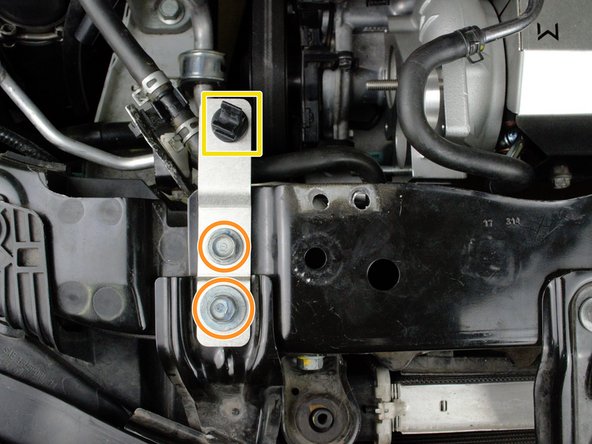 Locate the plastic hood prop clip from earlier and insert it into the square hole on the new hood prop bracket