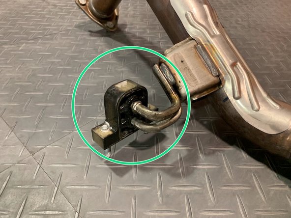 Using a spray cleaner, lubricate the front pipe hanger and remove it from the OE front pipe using tongue &amp; groove pliers