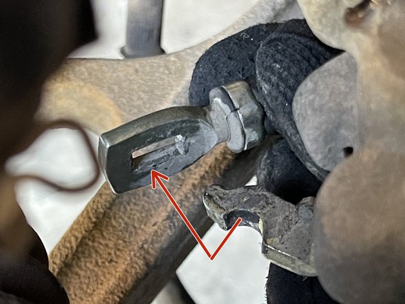 Remove the parking brake cable from the metal bracket