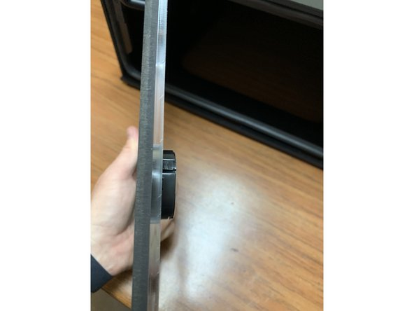 You may need to compress the tabs at the side of the hygrometer slightly and rotate back and forth to press it into the acrylic. It should be a snug fit.