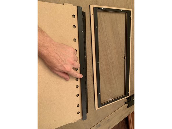 The unfinished side of the top panel faces the inside of the box. The photos are showing the top lid assembly turned upside down as if you were looking at it from inside the box.