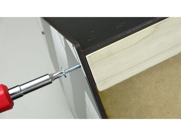 WALL MOUNT KIT: Using the cleat that has holes pre-drilled into the ends, line up the cleat to the back of the box and fasten with the 1" Truss Head Screws (the longer of the  screws) with a Phillips screwdriver. Fasten the top panel to the wood cleat using the 3/4" Truss Head screw.