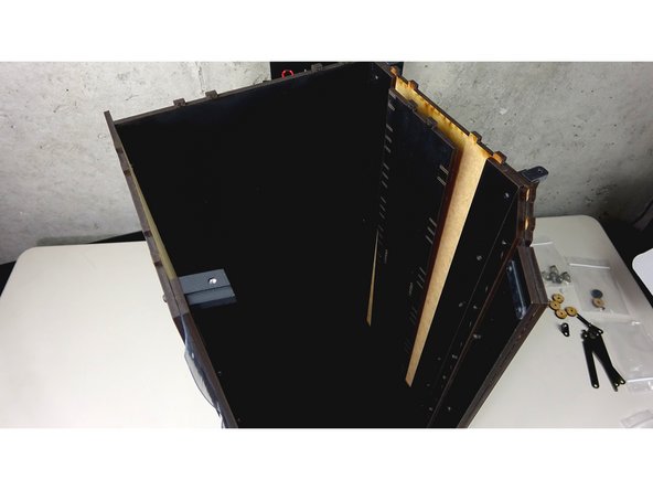 Tip the assembly over onto the side panel that is mounted.