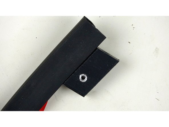 Place the Lip of the P Gasket (the part with the adhesive strip) into the indent of the Corner Bracket (as pictured in pic 3). Leave about 5mm of gasket hanging over the top of the bracket. We'll trim this later.