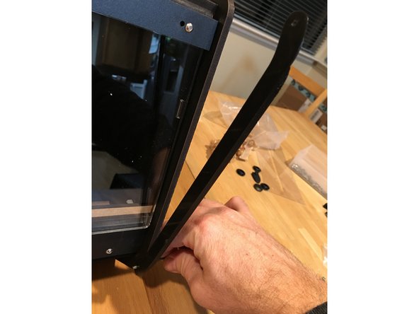 Bolt your 3D printed lid prop on to your preferred side of the RepBox using one 16mm bolt and a Nylock through the bottom holes of the side panel and lid prop.