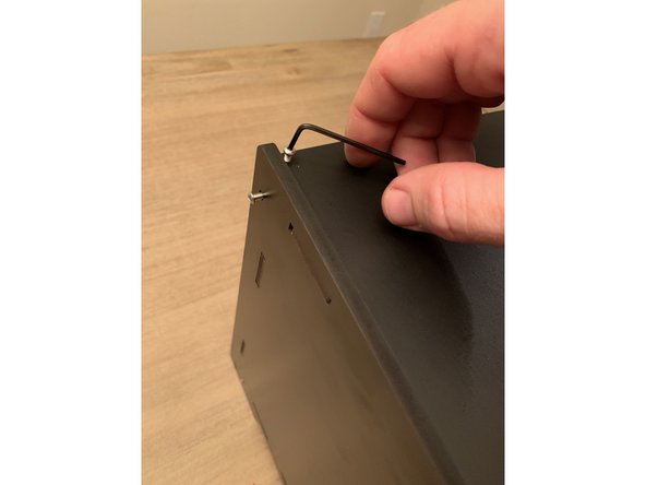 Fasten the top panel to each of the brackets installed on the back of the rear panel using five (5) 16mm screws.