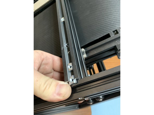 Insert 3 slide nuts into the top channel of the extrusion as shown.