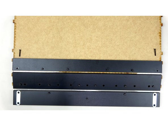 Place one of the prepared L brackets inside of the steel support beam facing outward. Secure it in place using one of the 20mm bolts. Insert the bolt from the opposite end so it catches the square nut in the bracket.