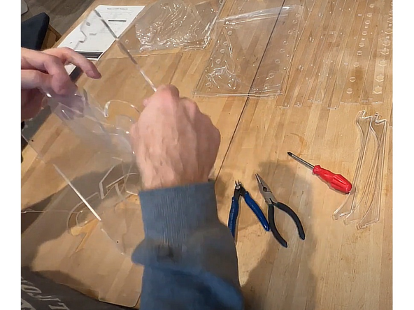 All clear acrylic panels come from the factory with a protective film on BOTH SIDES of the panel. Be sure to remove it all prior to assembly.