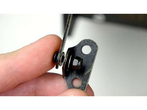 Insert a 10mm bolt through the end of the left Hinge arm