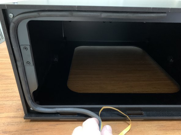 Remove the backing from the seal gasket and start pressing the Seal Gasket (Part 21) around the face of the Seal Flange. Start at the top center of the Seal Flange.