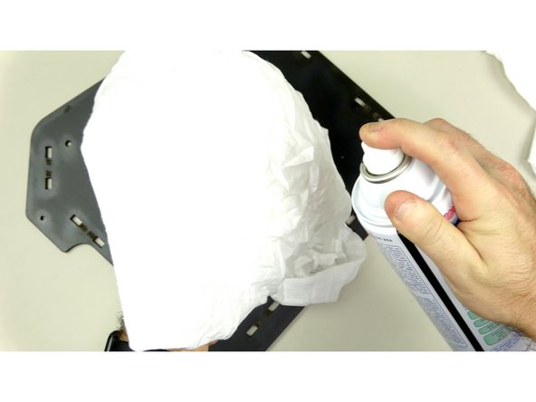 For best results, spray the rag with the cleaner and wipe down the 'glossy' spots until the  surface is matte.