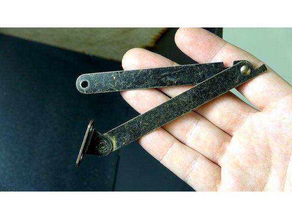 Grab the Lid Hinge with the end mount intact. It The second picture shows the orientation that it will be installed.