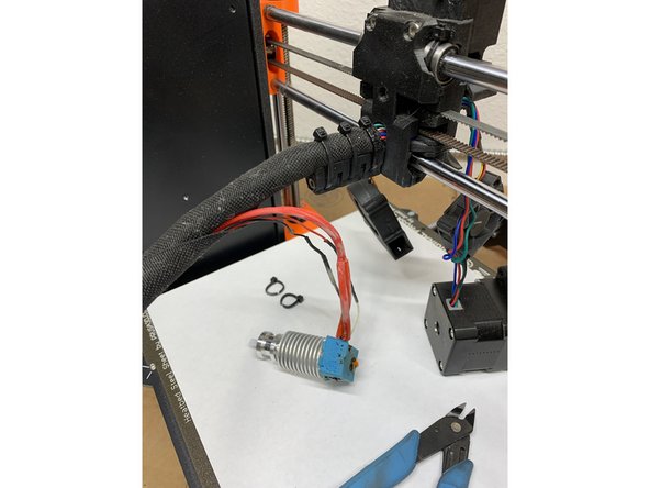 Disassemble and remove the stock v6 hot-end package per official E3D instruction steps 1-7.