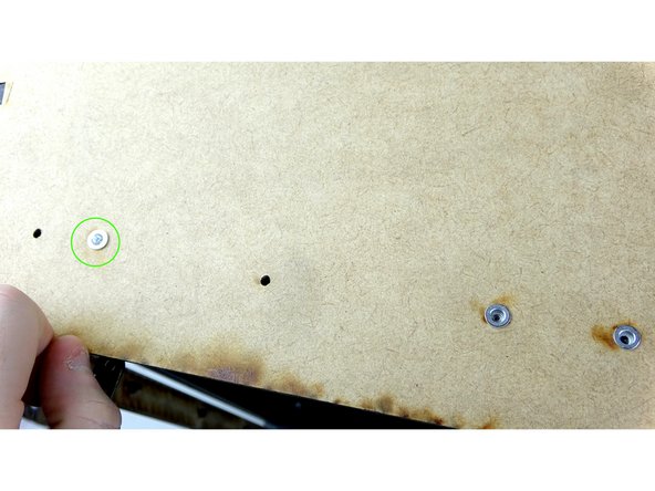 Insert a rivnut into the top larger hole of the side panel.