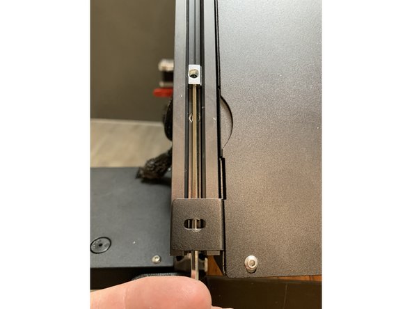 Using a hex key push the slide nut upwards in the extrusion as shown. If need be use a second hex key to hold it in place as you work it upwards in the extrusion past the electronics tray brackets.