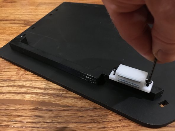 Attach the seal bar to the side panels with the 16mm bolts.