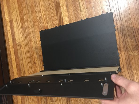 Lay the Back panel down, finished side up, and then insert the finished Base assembly into the tab holes as pictured.