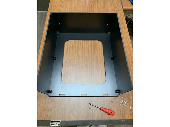Attach the remaining side panel to the base assembly with three TF screws as shown. Make sure the back edge lines up with the back edge of the base panel. When correctly installed it should look like picture 3.