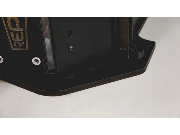 Carefully bend the front exit plate panel up to insert into the tab holes. Your nylock nuts should still be semi loose to aid in the poisoning.