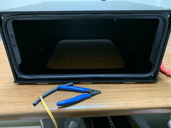 There are three notches along the base at the box's front.  The seal gasket should be lined up AS FAR from those notches as possible, at the top edge of the seal flange. This will allow you to more easily put the lid in place.