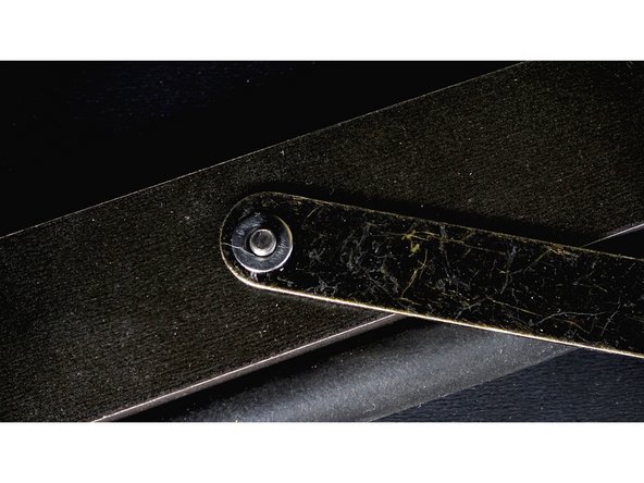 Place the arm onto the bolt, followed by a washer.