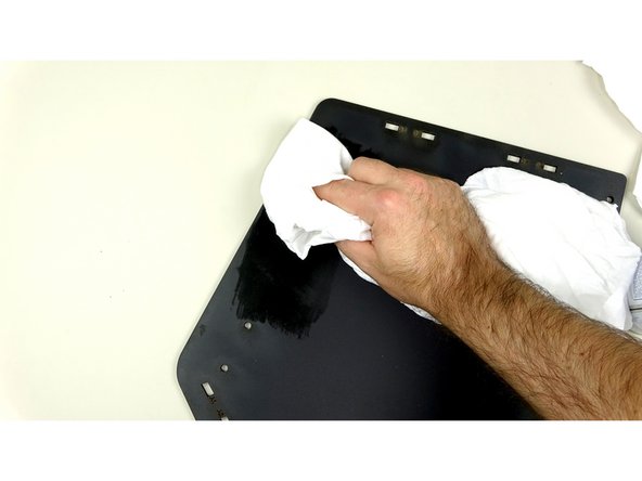 For best results, spray the rag with the cleaner and wipe down the 'glossy' spots until the  surface is matte.
