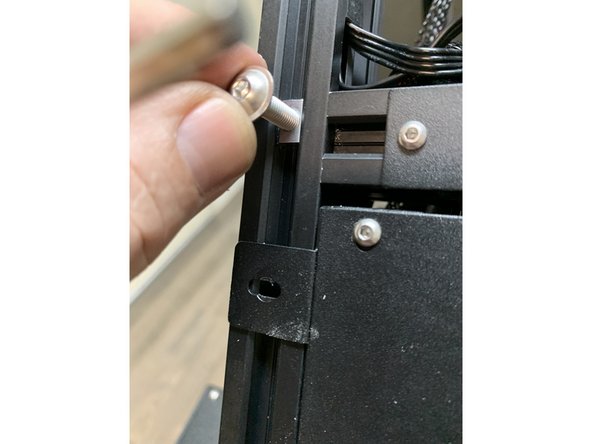 Temporarily add a screw to hold the slide nuts in place above the electronics tray brackets as shown.